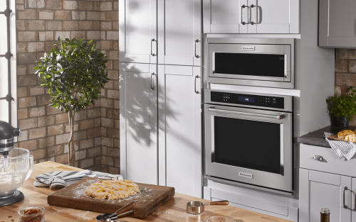 A KitchenAid® built-in microwave in a rustic kitchen