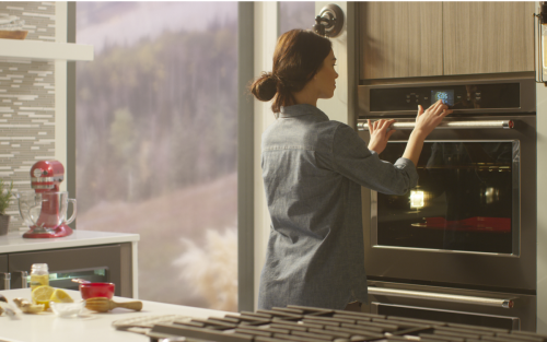 Person selecting settings on KitchenAid® wall oven