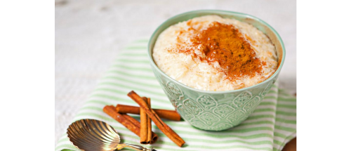 A bowl of rice pudding topped with cinnamon