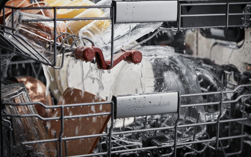 Closeup of the inside of KitchenAid® dishwasher with water spraying on the dishes