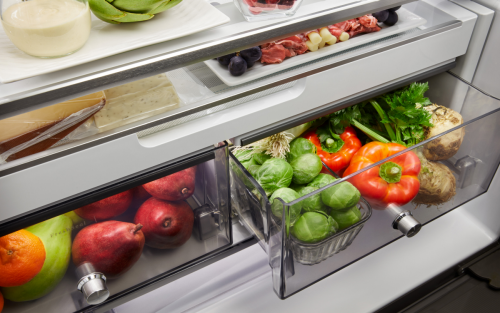 Fresh fruits and vegetables stored in a refrigerator crisper drawer