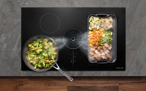 Overhead view of food cooking on an induction cooktop