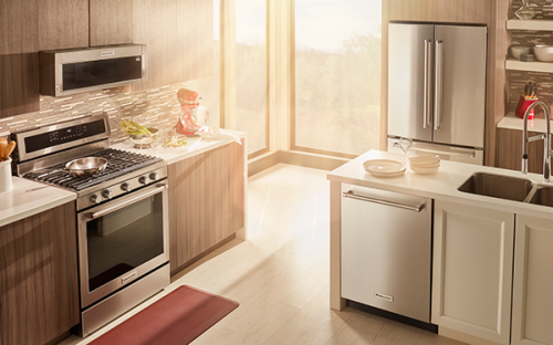 KitchenAid® dishwasher and commercial range in a kitchen