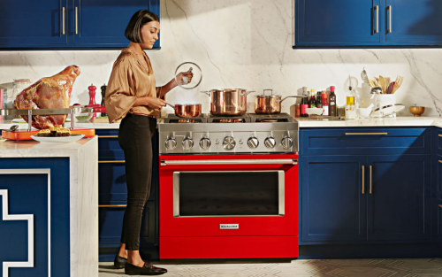 Red KitchenAid® range set in blue, modern kitchen