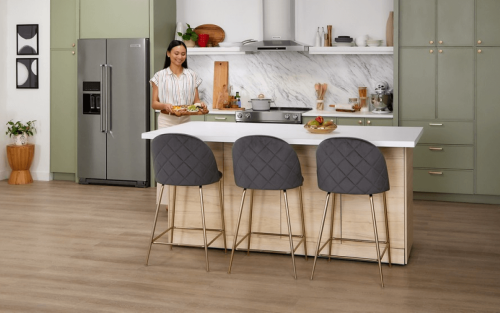 Person setting an hors d'oeuvre platter on a kitchen island