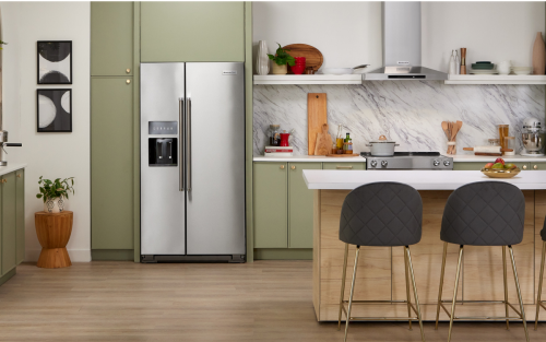 KitchenAid® side-by-side refrigerator built into green cabinetry