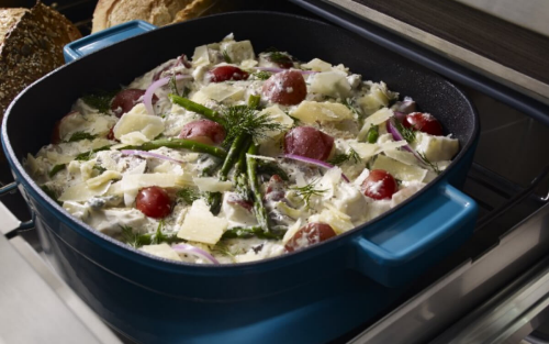 Close-up of garnished au gratin in a blue ceramic casserole dish