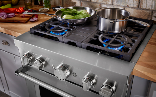 Person cooking on a gas cooktop