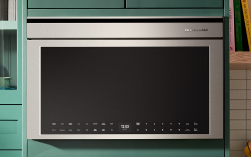 Stainless steel KitchenAid® over-the-range microwave in bright blue cabinetry