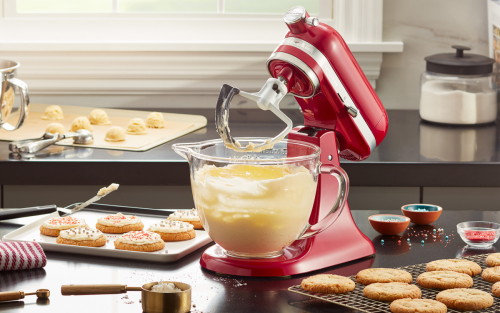 A red KitchenAid® stand mixer used to make cookie batter