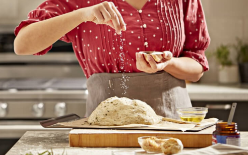 A woman preparing dough for homemade bread