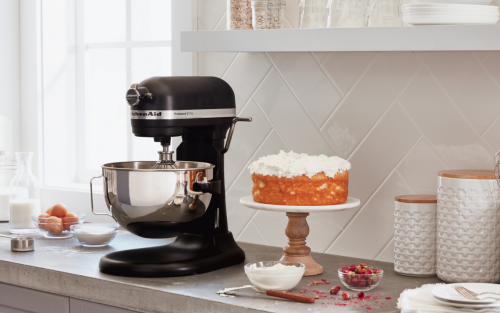 KitchenAid® bowl lift stand mixer with finished cake next to it.