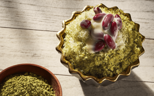 Korean shaved ice dessert topped with red beans and matcha powder