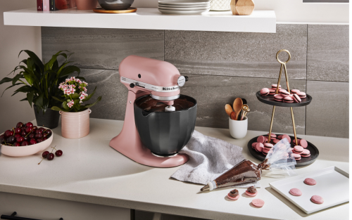 Pink KitchenAid® stand mixer next to pink macarons