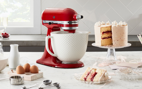 Red stand mixer with buttercream frosted cake