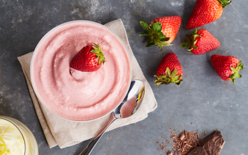 Bowl of Italian ice with strawberries and lemon