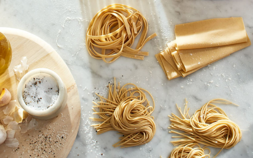 Homemade pasta and KitchenAid® pasta attachments on counter