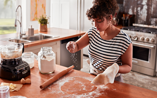 A woman preparing dough