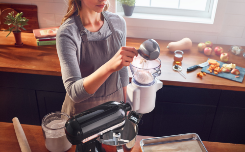 Person sifting flour in a stand mixer sifting attachment