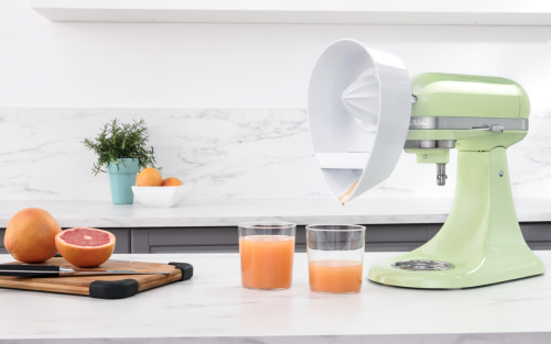 Fresh juice made with a green KitchenAid® stand mixer and Citrus Juicer Attachment