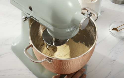 KitchenAid® stand mixer with dough hook mixing dough