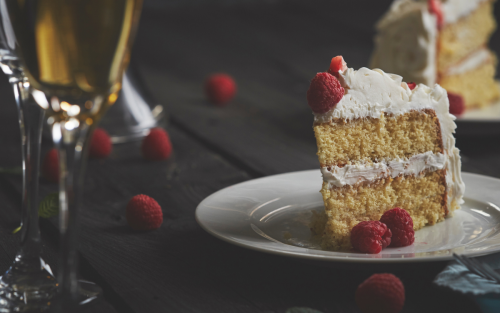 Slice of vanilla cake on white plate