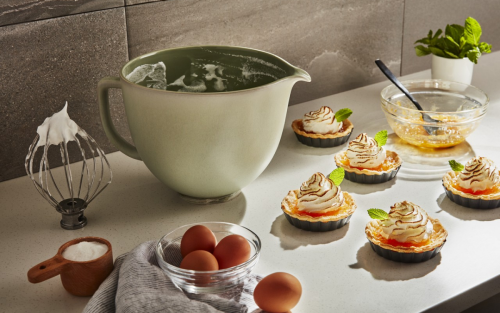 Ceramic KitchenAid® Stand Mixer Bowl next to tartes topped with meringue