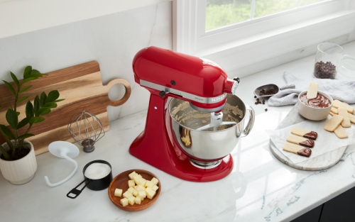 KitchenAid® Stand Mixer on a countertop surrounded by various sweet ingredients