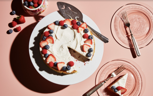 A blueberry and strawberry pavlova on a serving plate.