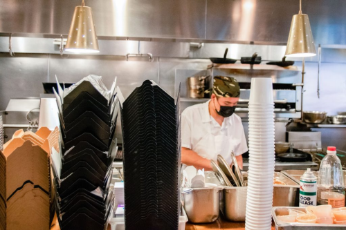 A chef working in the restaurant kitchen of Myers + Chang.