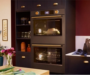 A built-in wall oven against a red wall