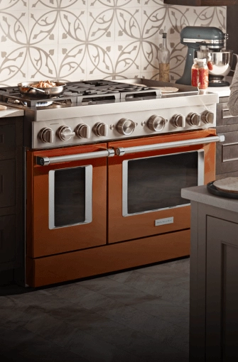 A scorched orange KitchenAid® commercial-style range