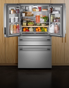 A large KitchenAid® refrigerator fully stocked with fresh ingredients and packaged food items