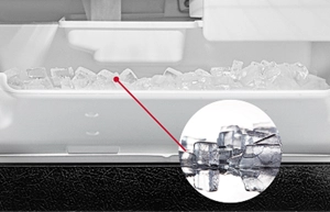 A close up of ice production in an ice maker