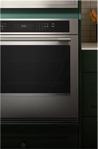 A single wall oven in a green contemporary kitchen.