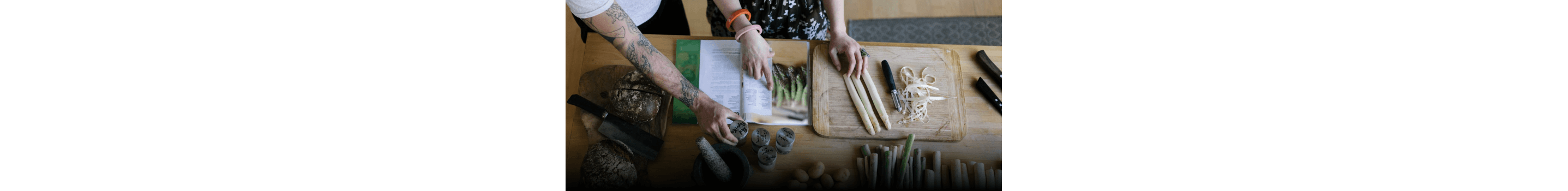 Two people following a recipe featuring asparagus.