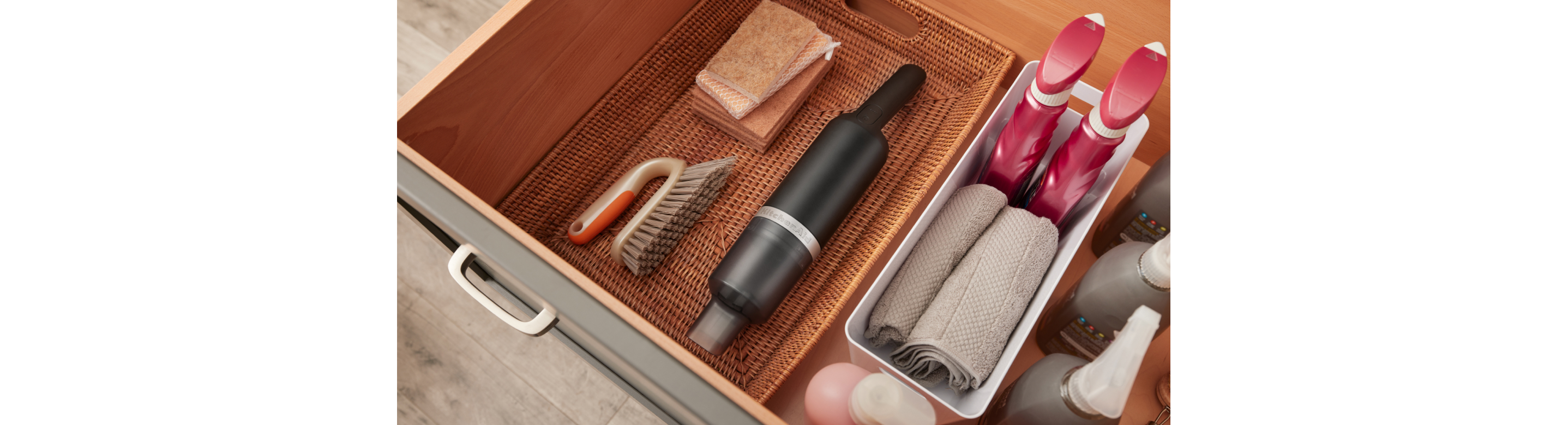 KitchenAid Go™ Cordless Kitchen Vacuum in a basket in a drawer.