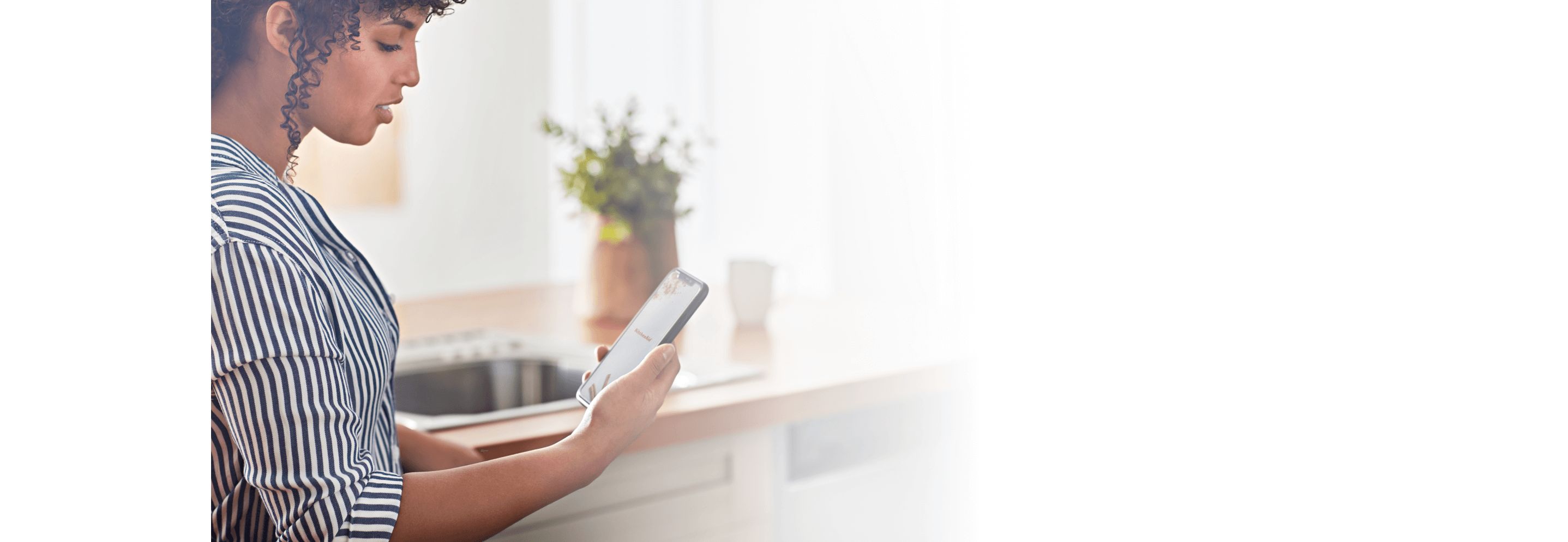 A woman familiarizing herself with her new KitchenAid™ app.