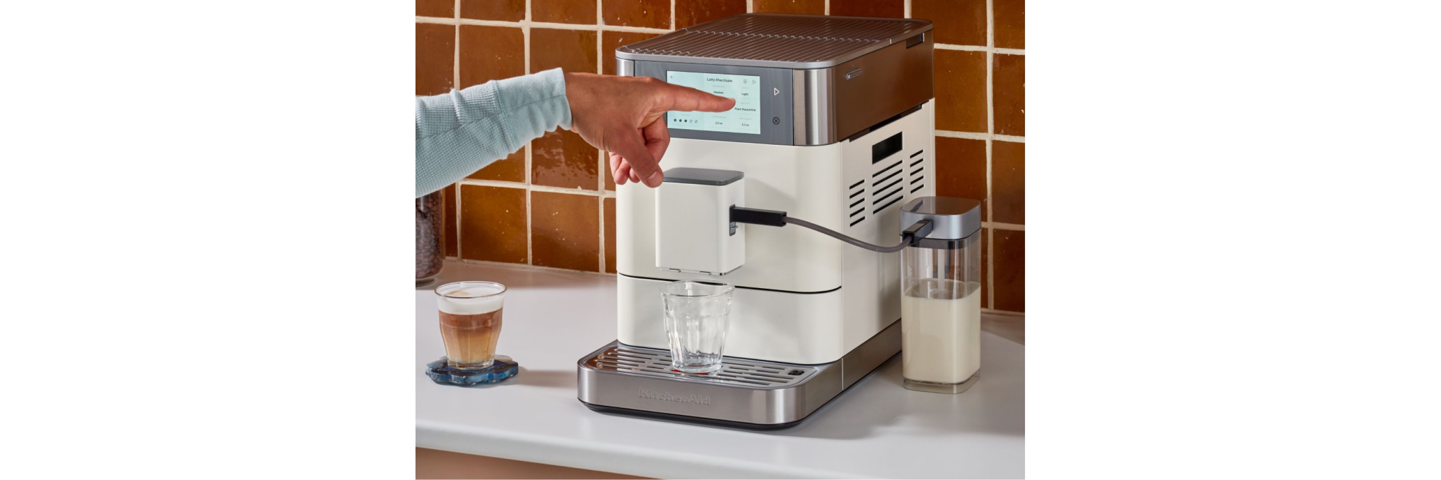 A person making espresso with a KitchenAid® Espresso Machine.