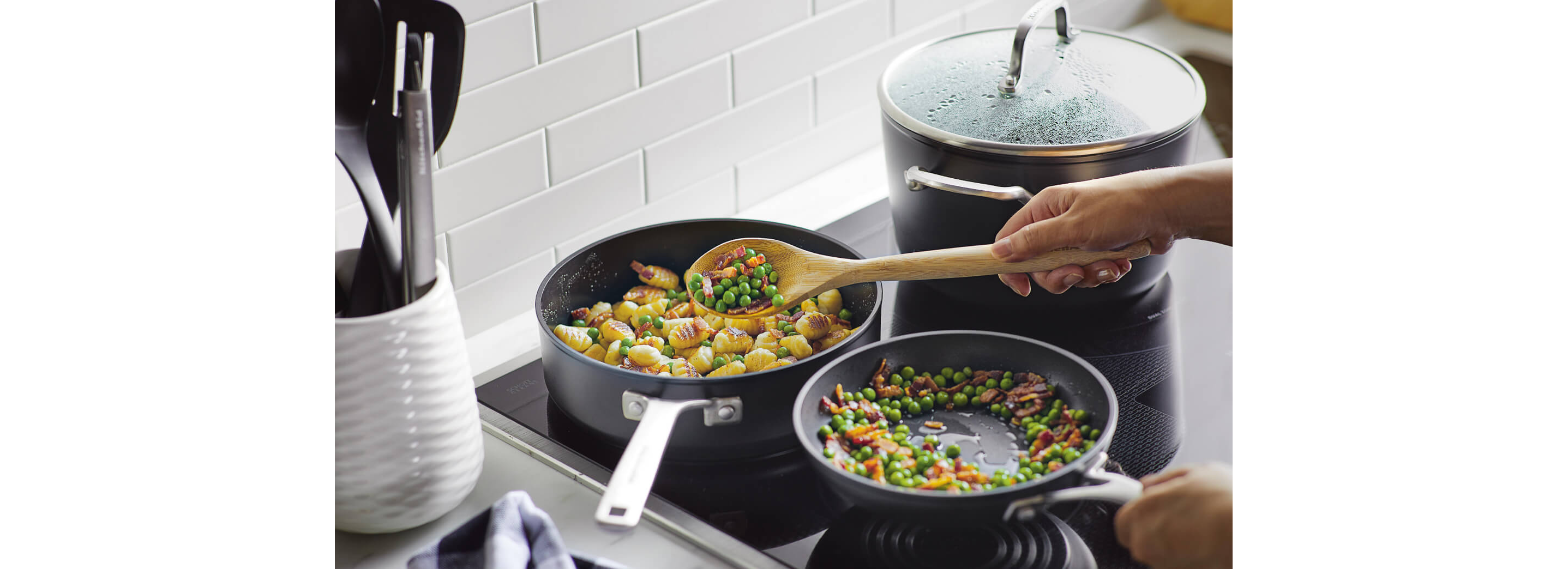 A person cooking with a hard-anodized induction pan.