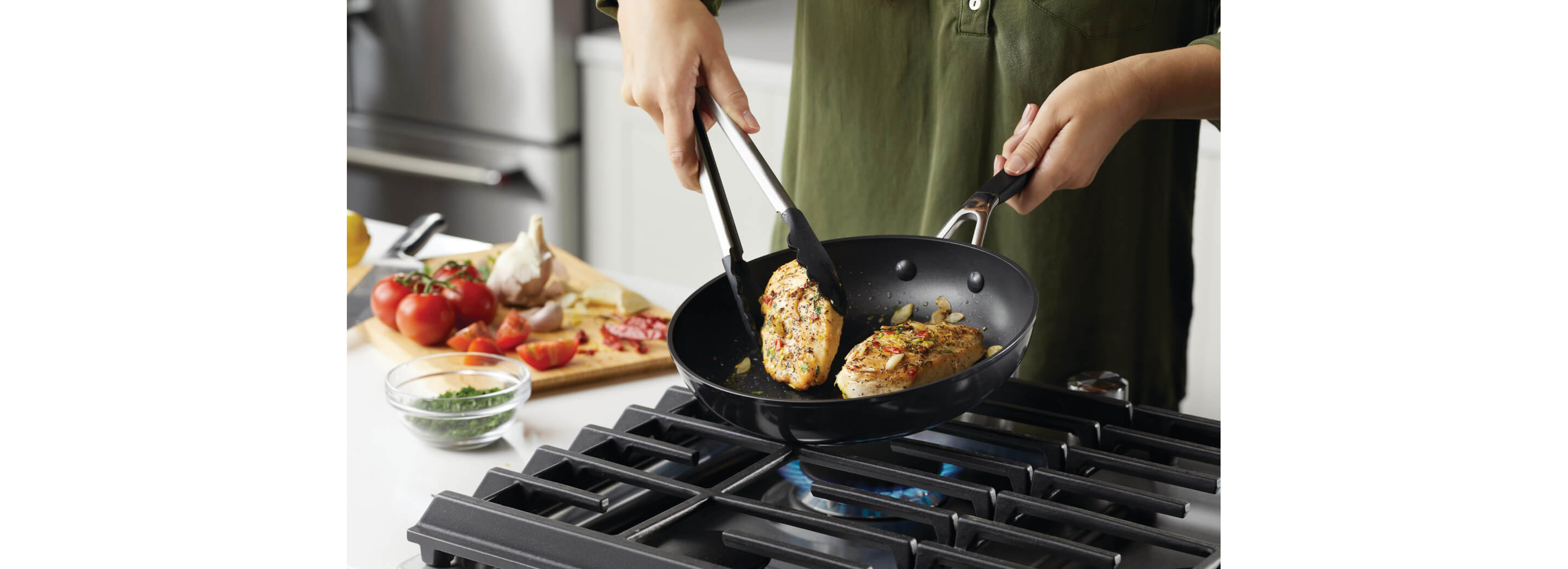 A person cooking with hard-anodized pans.