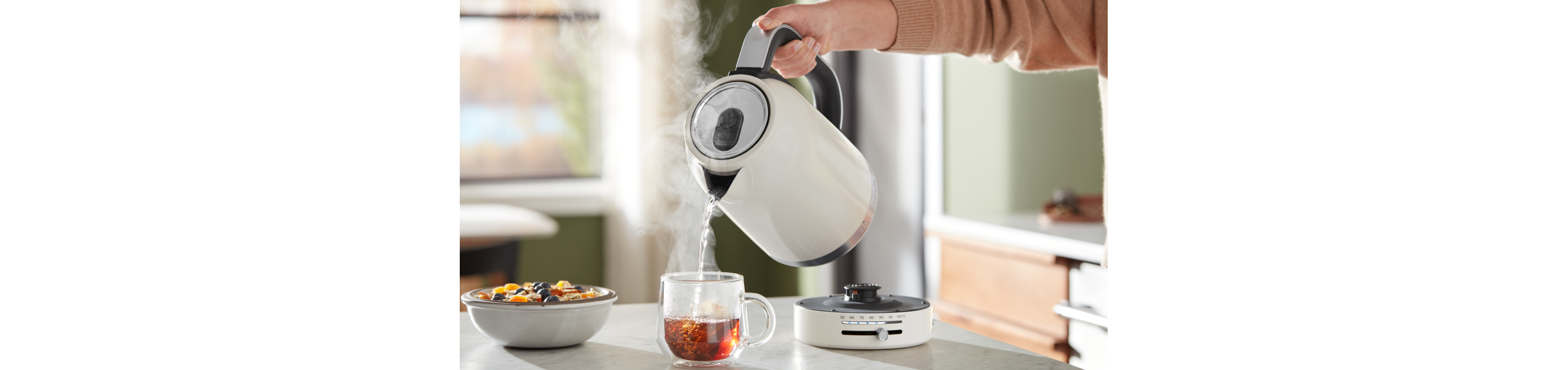 A person pouring hot water into oats.