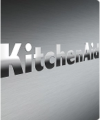 A close up of the embossed KitchenAid brand logo on the stainless steel range.