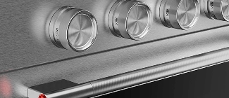A close-up on the handles and knobs of a Stainless Steel range.