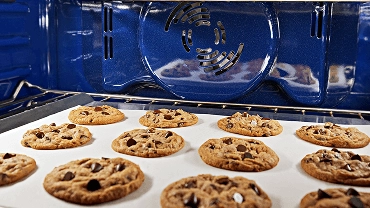 A tray of cookies baking inside an oven.