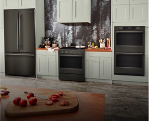 A suite of Black Ore appliances in a white kitchen.