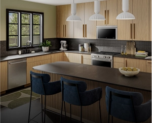 A suite of stainless steel appliances in a light wooden kitchen.