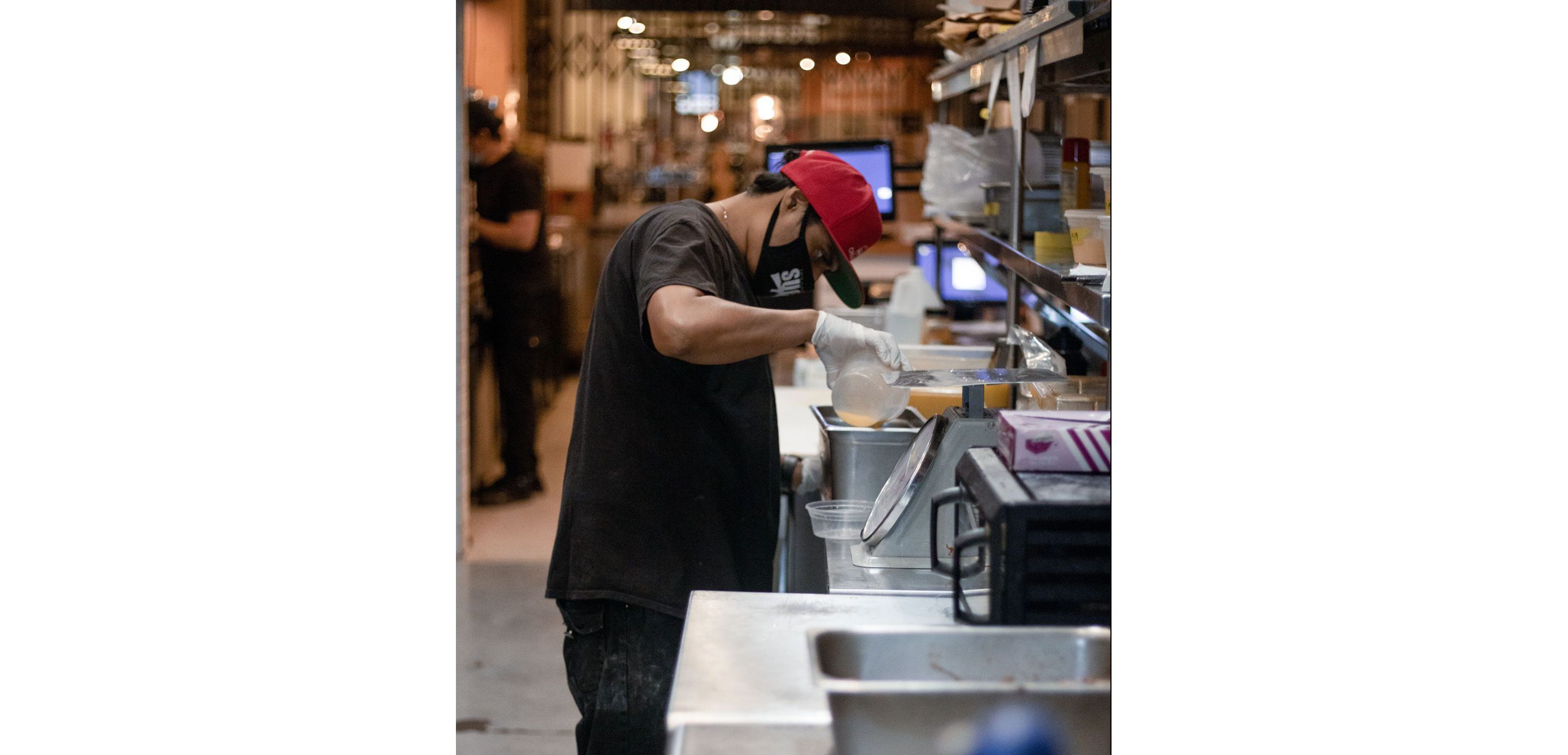 A person diligently prepping in in the Pulkies kitchen.