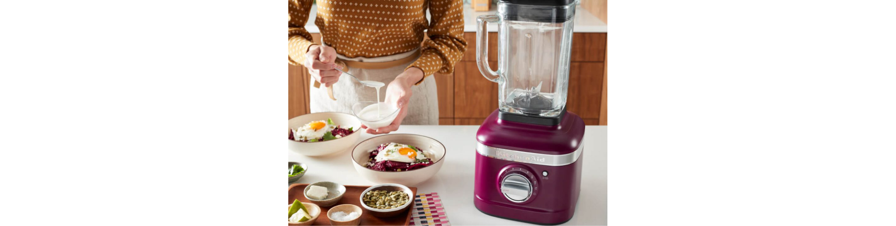 A Beetroot blender on a counter near two egg-topped bowls of food.