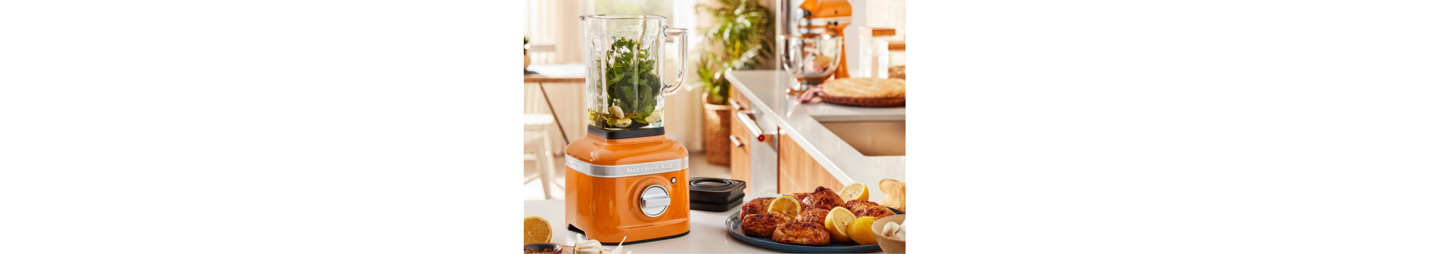  A honey blender filled with bright green ingredients.